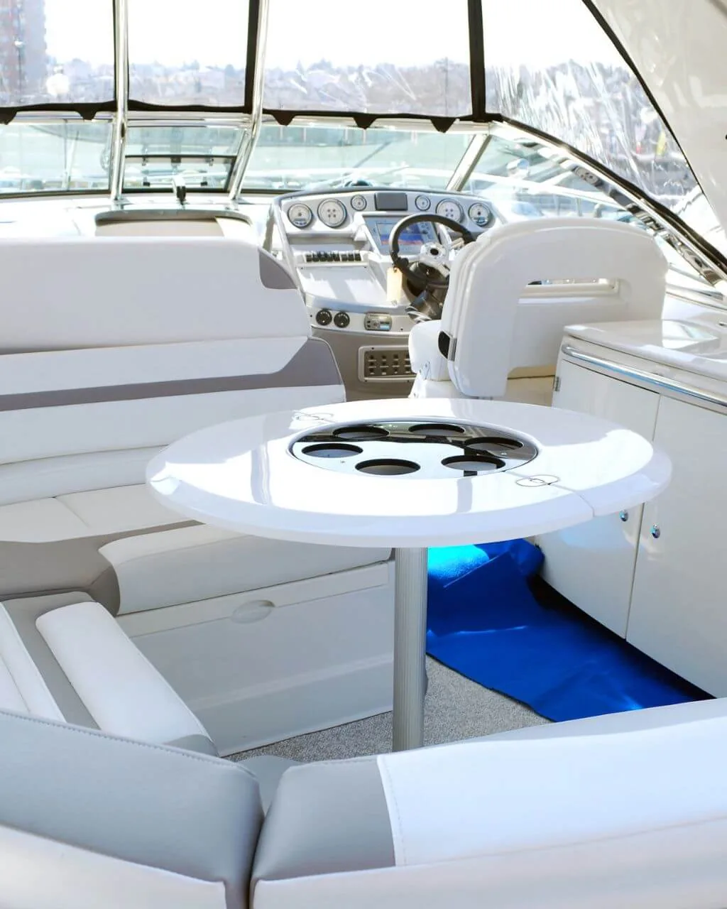 Clean white boat cabin upholstery and helm seating after detailing