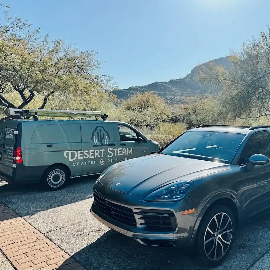 Freshly detailed luxury SUV beside the Desert Steam van